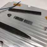 Fabrisonic's SmartPlate with optical strain gauges and thermal sensors built into the metal.